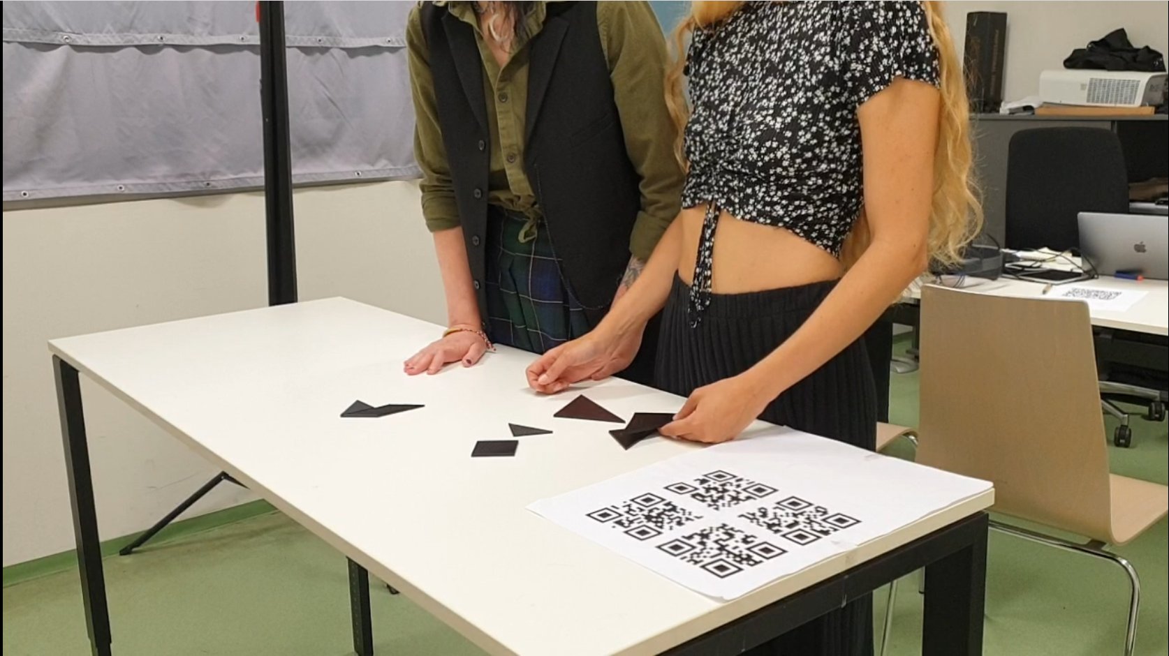 Two participants working on the tangram puzzle together